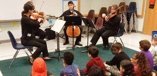 Faculty chamber group performing at local school