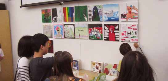 Students showing artwork at exhibit