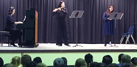 Chamber trio performing at local school