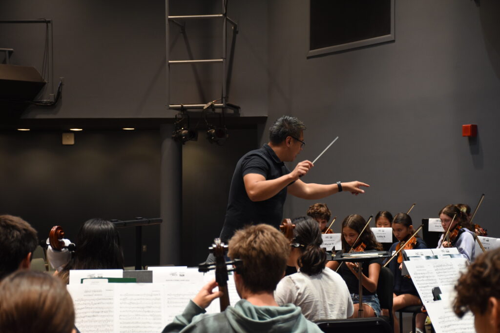 dr. soo han conducting the high school orchestra