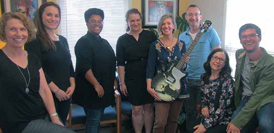 Academy staff with Dale Earnhardt guitar