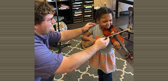 Drew Robertson teaching young child