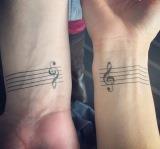 Music tattoos on wrists