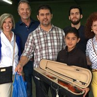Student holding violin in Costa Rica