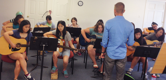 Guitar students rehearsing at summer camp