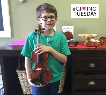 Young violin student receives violin to play