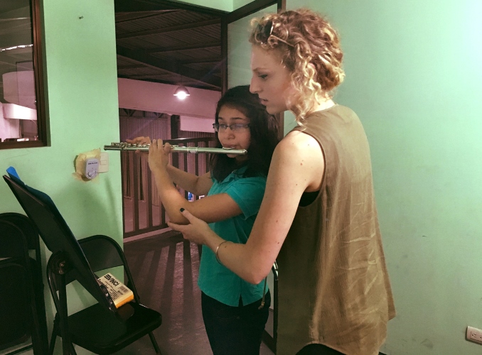 Krista Pack helps a flute student in Costa Rica