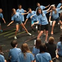 Students rehearsing at musical theater summer camp