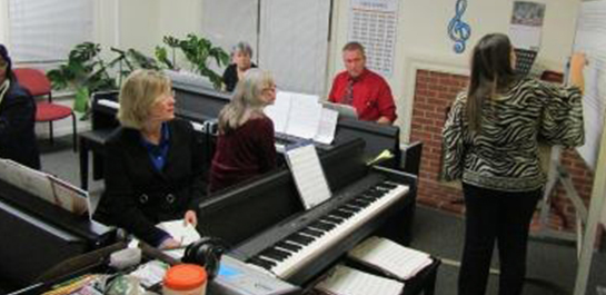 Ina teaching older adults in piano class