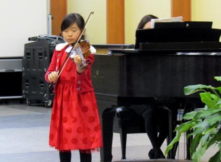 Young violinist at music recital