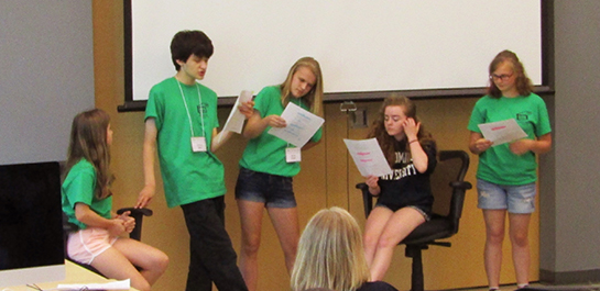 Students reading at summer screenwriting workshop