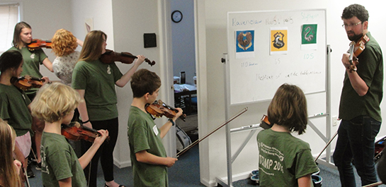 Violin students learning at summer camp