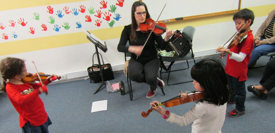 Students playing in violin class