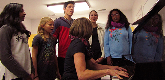 Teens singing in voice class