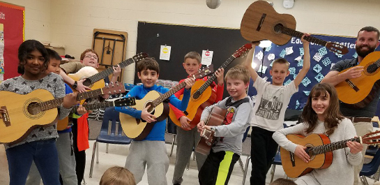 Students playing donated guitars