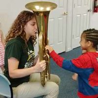 Child learning about musical instruments