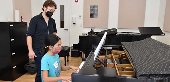 Summer piano camp student and teacher