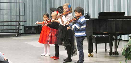 Violin students performing at recital