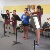 Students practicing at summer violin camp