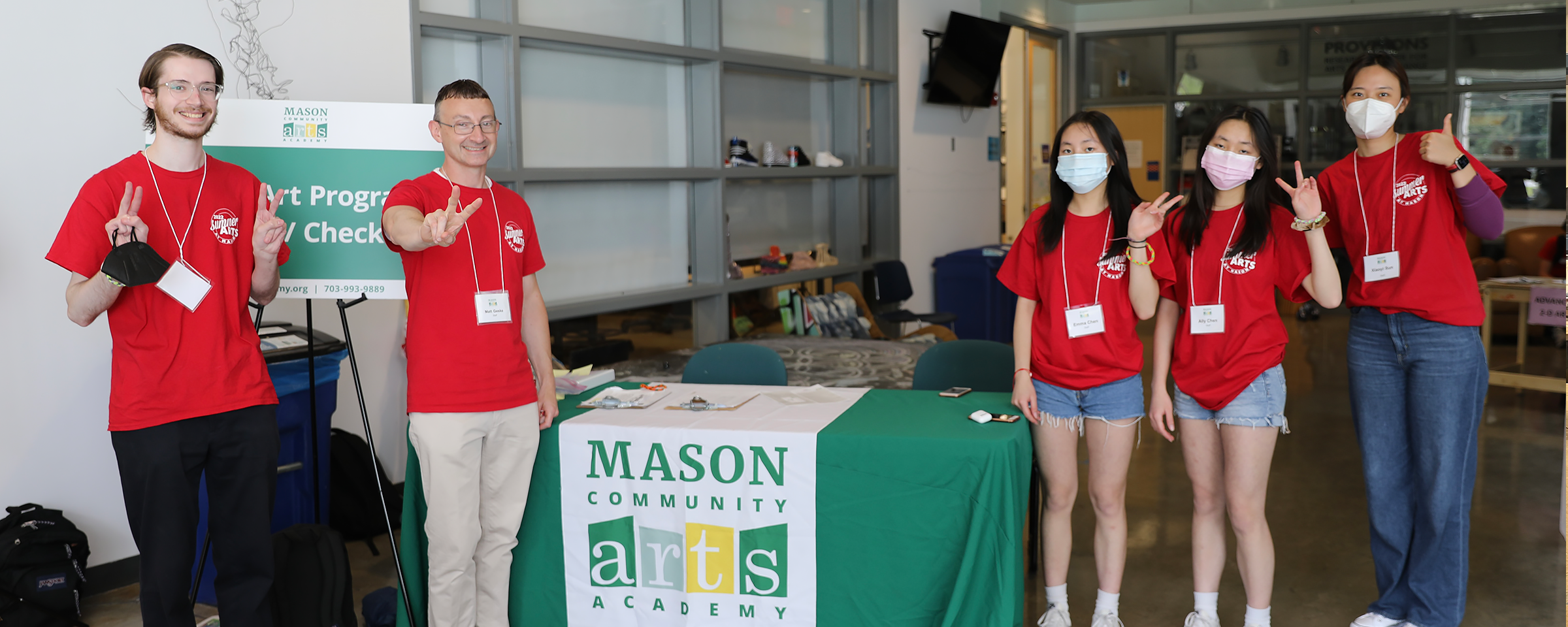 Interns posing with a peace sign at the famera