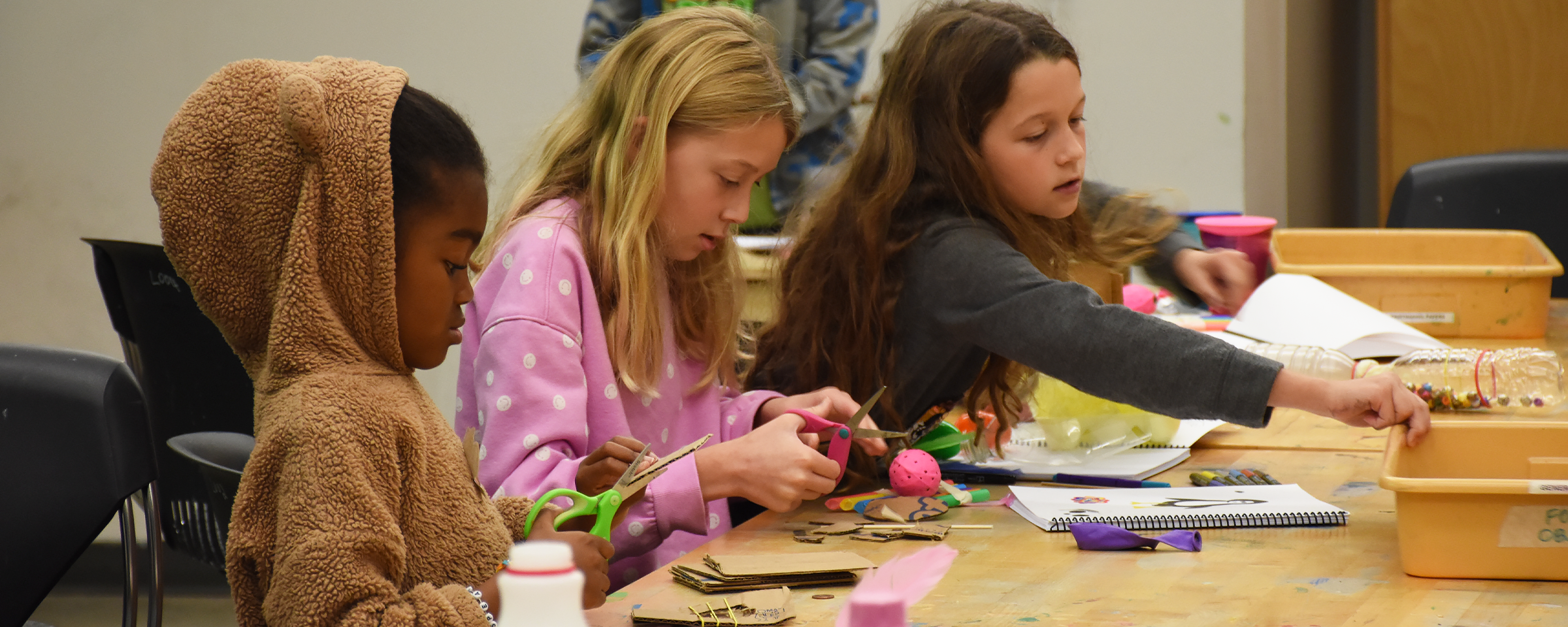 Kids working on small projects in their art class.