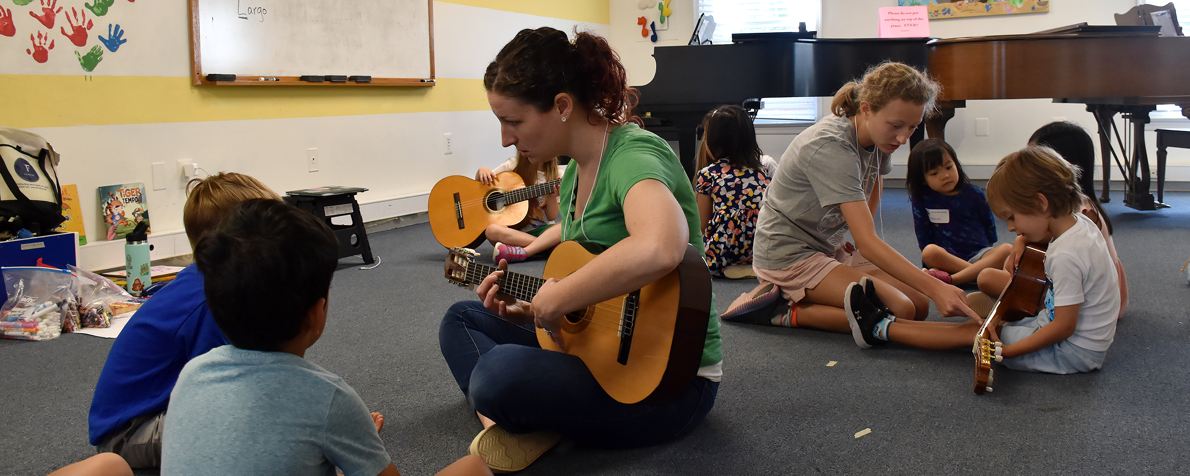 kids exploring the guitar