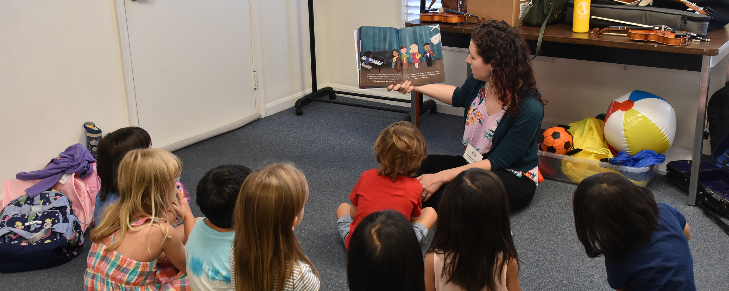 kids being read a story from a music book