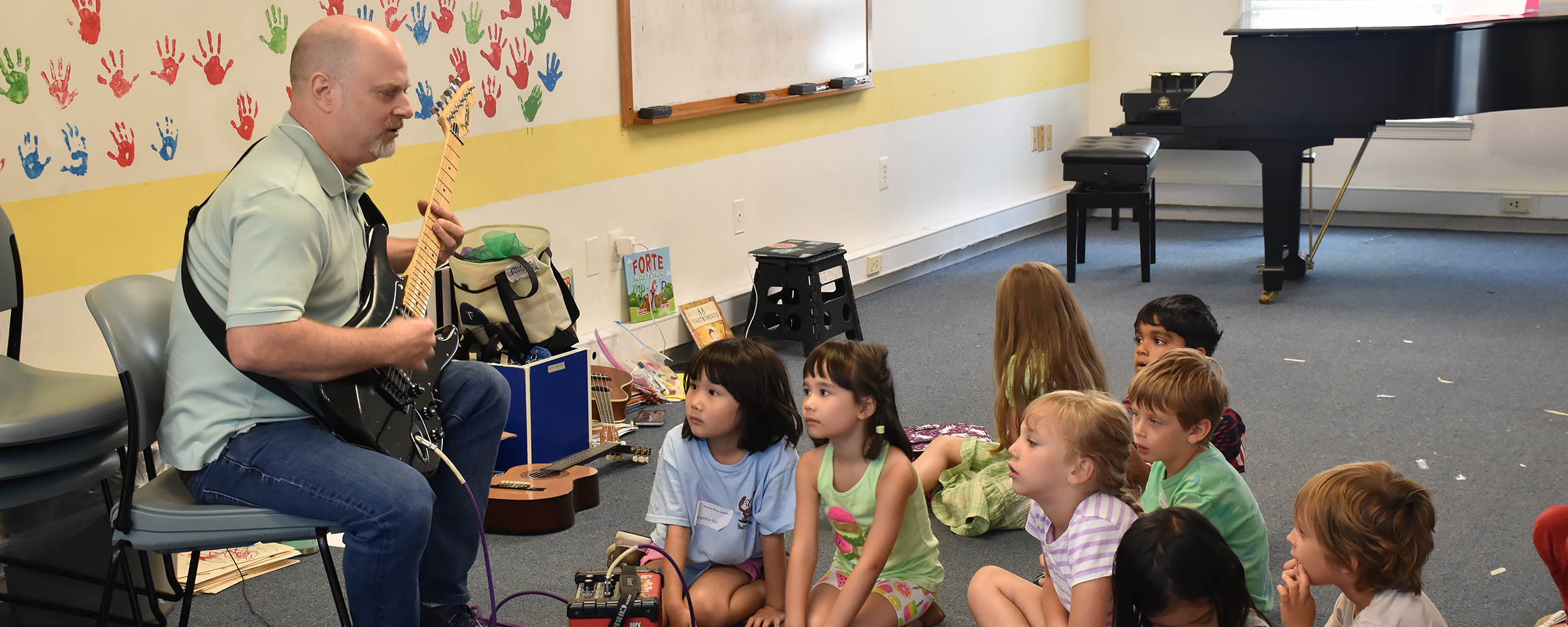 kids learning about the guitar