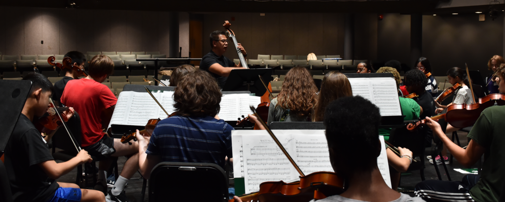 high school students rehearing in an orchestra